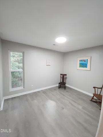 a view of a livingroom with wooden floor and closet