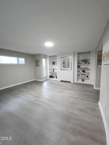a large kitchen with a stove and white cabinets