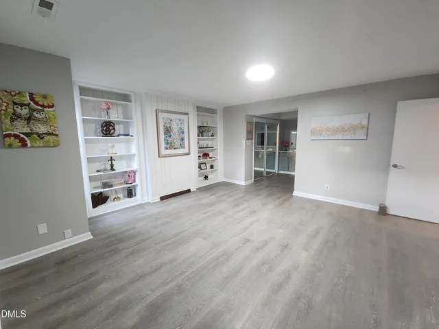 a view of an empty room with a painting on the wall