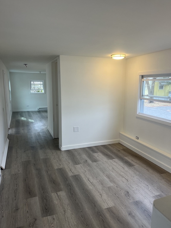 32 Better Way Springfield, MA 01119 - Photo 3 of 7 an empty room with wooden floor and windows