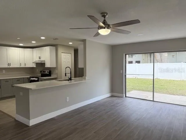 a view of kitchen with wooden floor and window