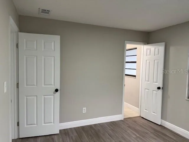 an empty room with wooden floor