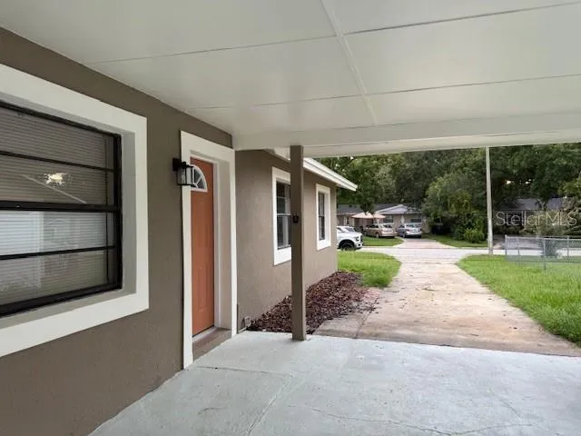 a porch with seating space and garden view