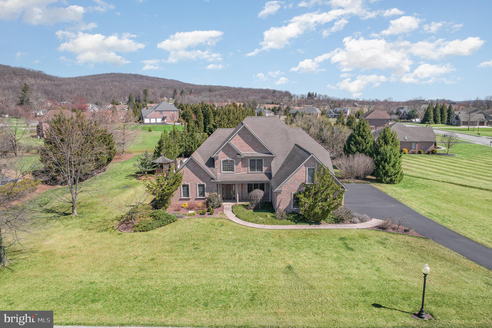 an aerial view of residential houses with outdoor space and trees