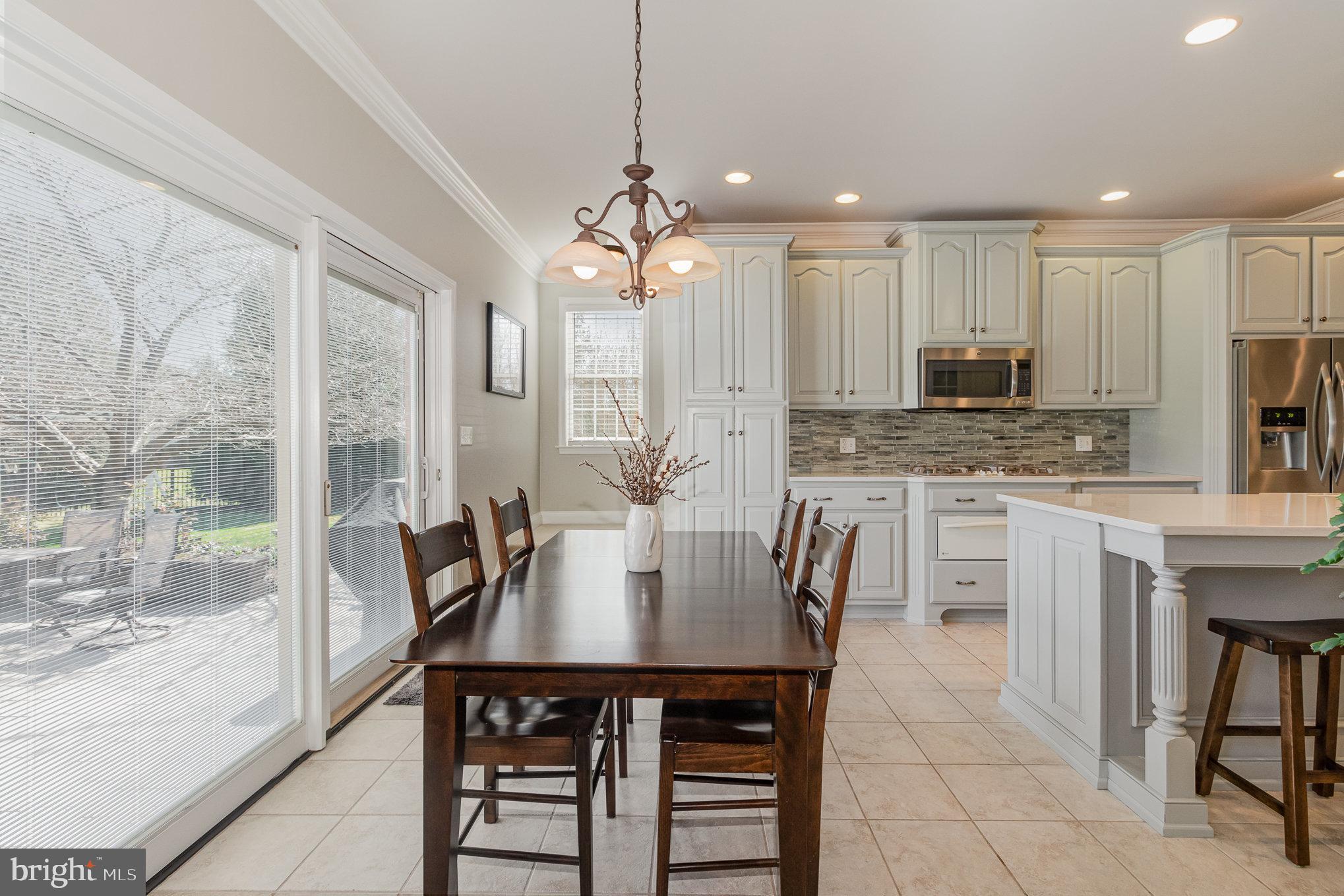 140 Madara Drive Hanover, PA 17331 - Photo 11 of 57 a kitchen with kitchen island granite countertop a table chairs sink and cabinets
