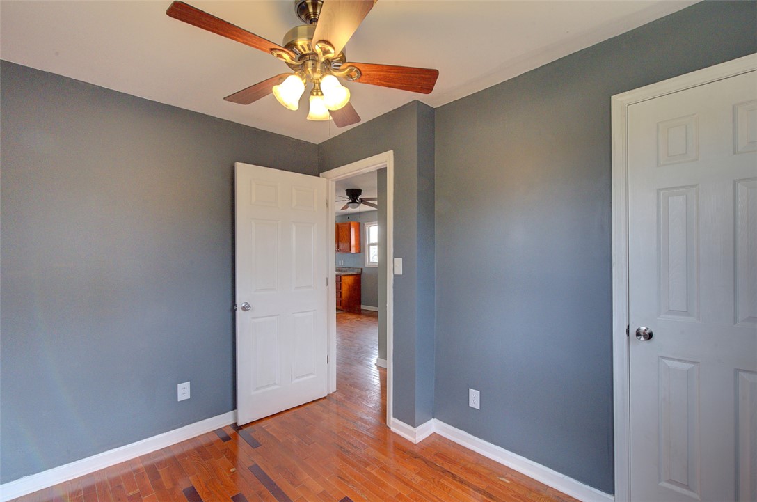 325 Rock Quarry Road Travelers Rest, SC 29690 - Photo 20 of 37 This inviting bedroom features rich hardwood flooring and a functional ceiling fan.