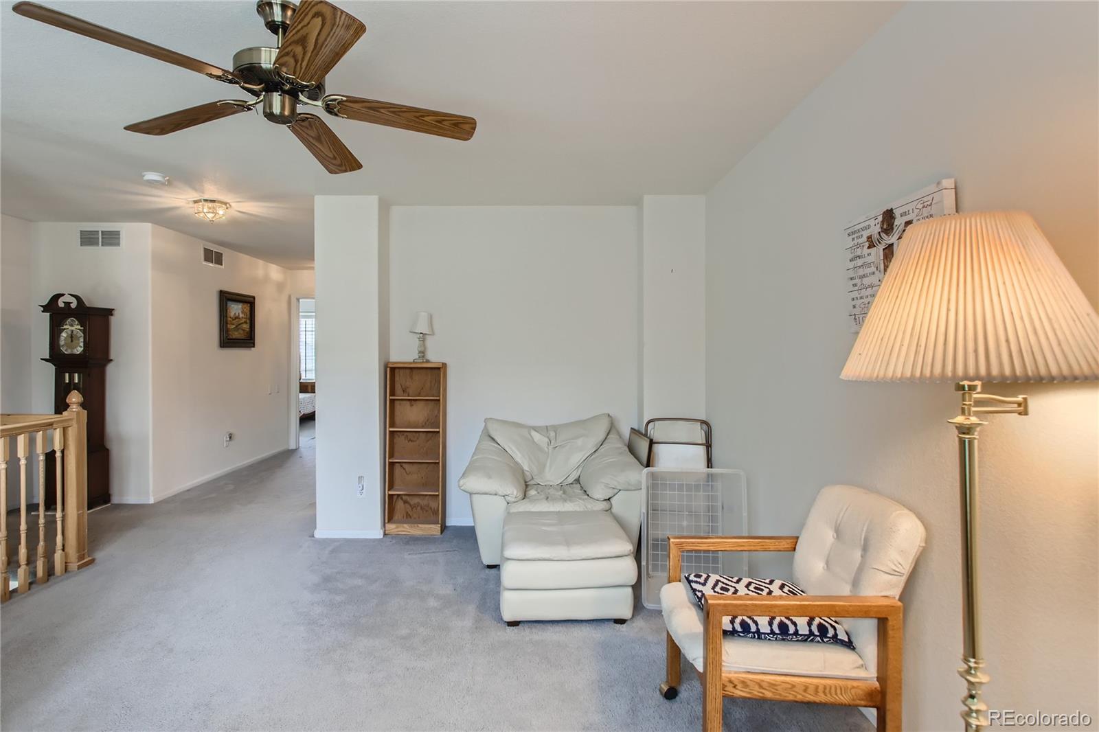 6247 Trailhead Road Highlands Ranch, CO 80130 - Photo 21 of 28 a living room with furniture and a chandelier