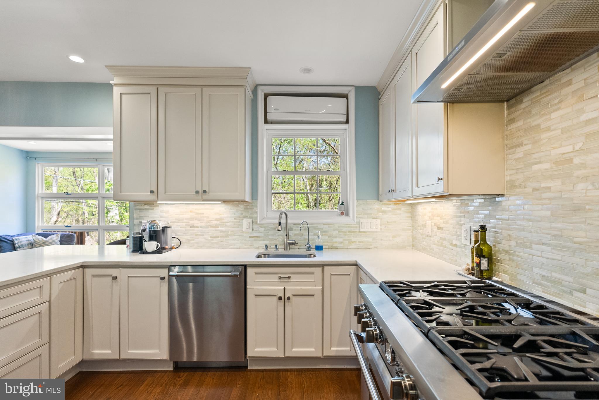 1511 44th Street Northwest Washington, DC 20007 - Photo 11 of 37 a kitchen with a sink stove top oven and cabinets