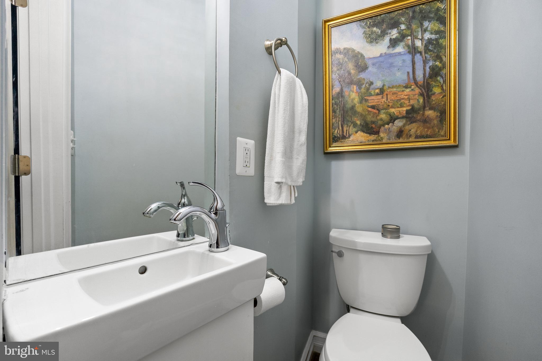 1511 44th Street Northwest Washington, DC 20007 - Photo 16 of 37 a bathroom with a toilet a sink and mirror