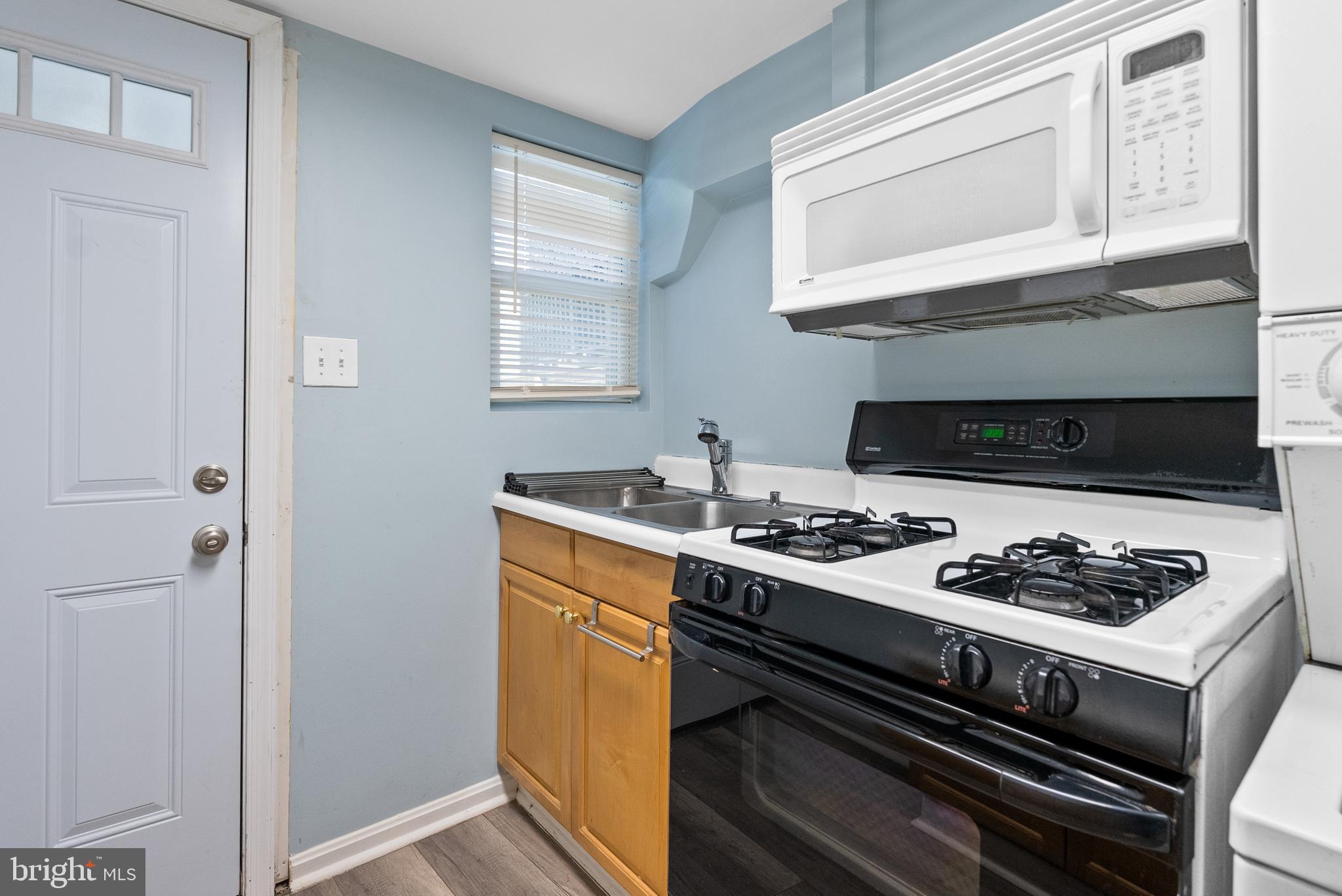 1511 44th Street Northwest Washington, DC 20007 - Photo 24 of 37 a kitchen with a stove and a cabinet