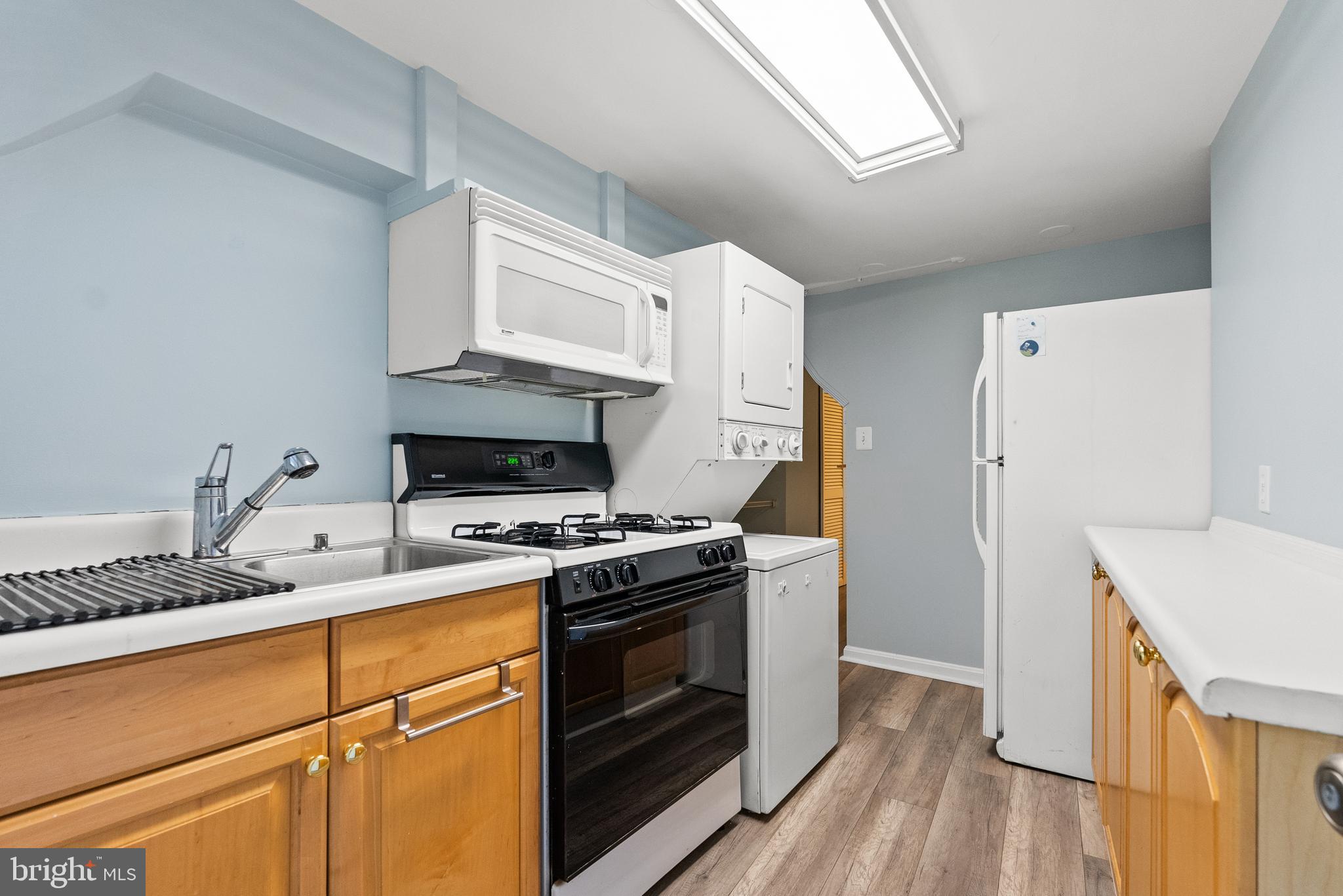 1511 44th Street Northwest Washington, DC 20007 - Photo 25 of 37 a kitchen with a stove cabinets and wooden floor