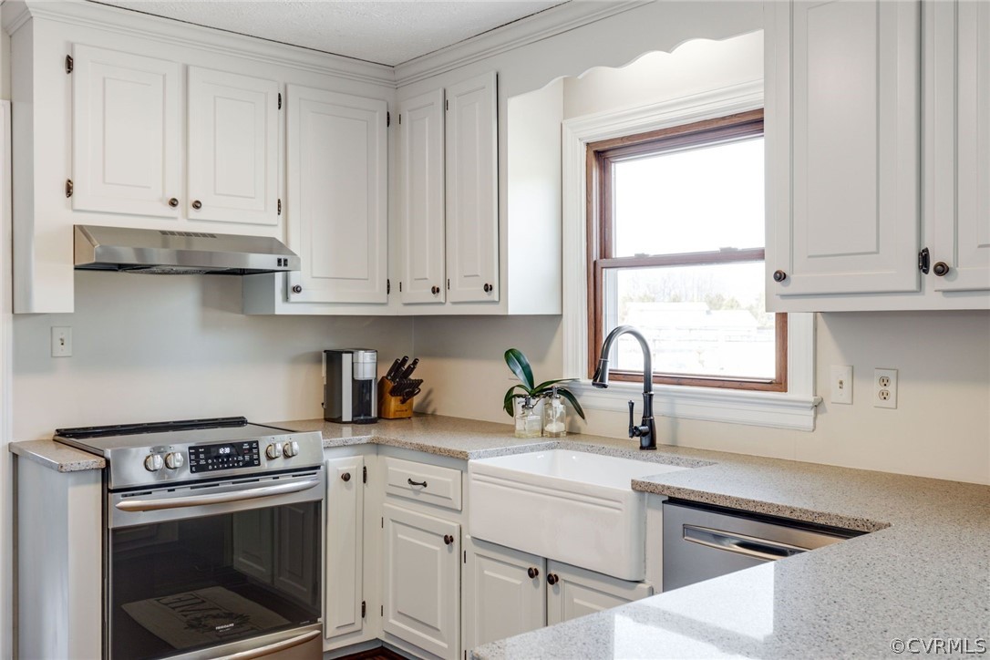 11054 Georgetown Road Mechanicsville, VA 23116 - Photo 13 of 50 a kitchen with stainless steel appliances granite countertop a stove a sink and white cabinets