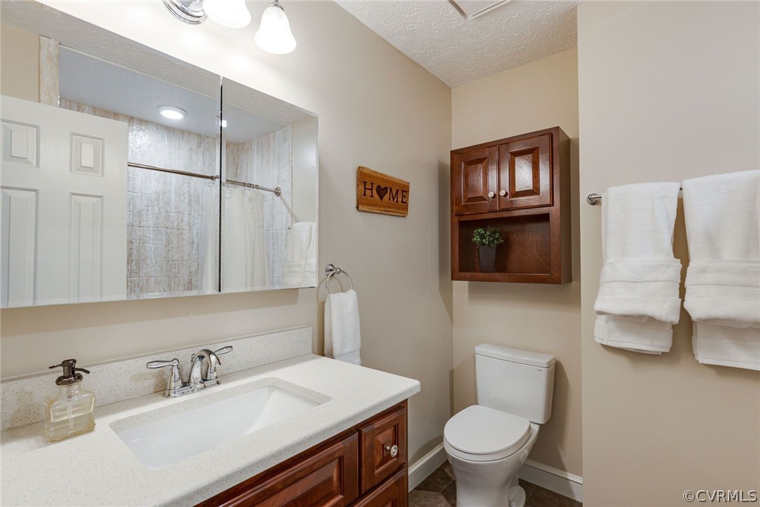 11054 Georgetown Road Mechanicsville, VA 23116 - Photo 20 of 50 a bathroom with a sink a toilet and a mirror