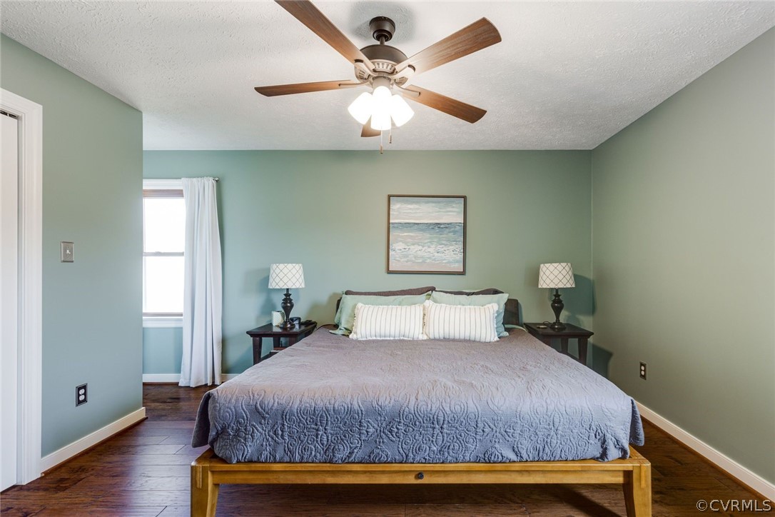 11054 Georgetown Road Mechanicsville, VA 23116 - Photo 21 of 50 a bedroom with a bed and a chandelier