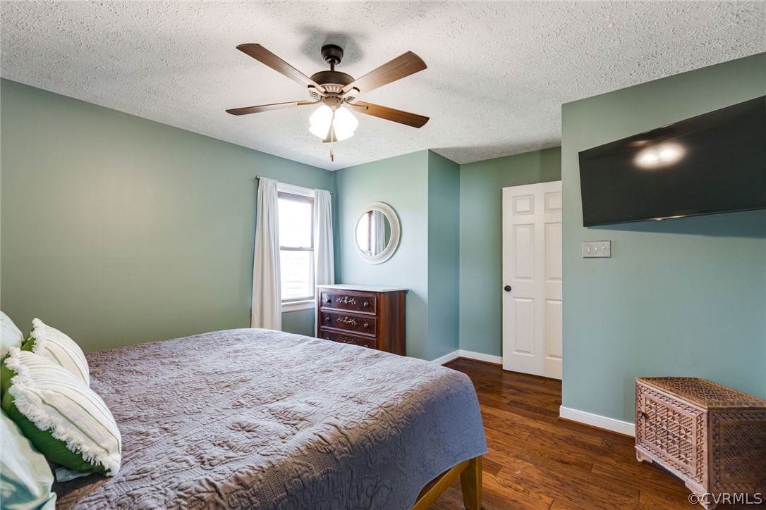 11054 Georgetown Road Mechanicsville, VA 23116 - Photo 22 of 50 a bedroom with a large bed and a chandelier