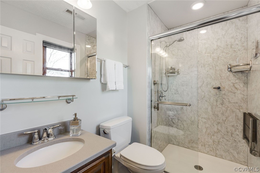 11054 Georgetown Road Mechanicsville, VA 23116 - Photo 23 of 50 a bathroom with a sink toilet a mirror and shower