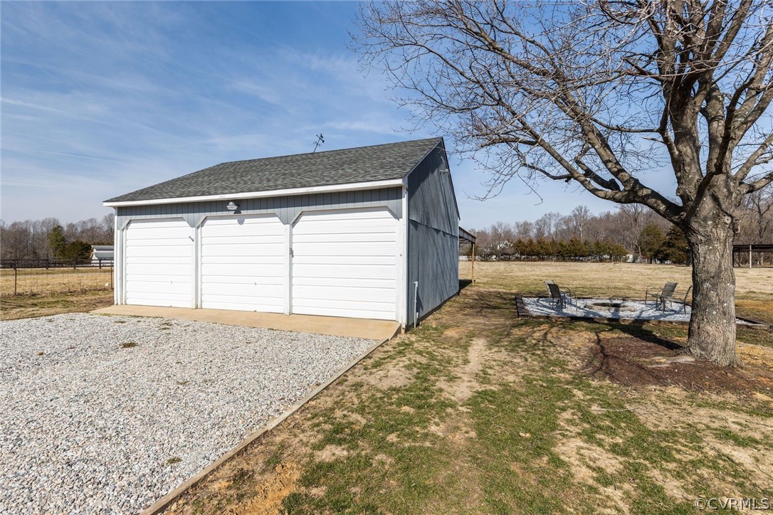 11054 Georgetown Road Mechanicsville, VA 23116 - Photo 32 of 50 a backyard of a house with a yard and garage