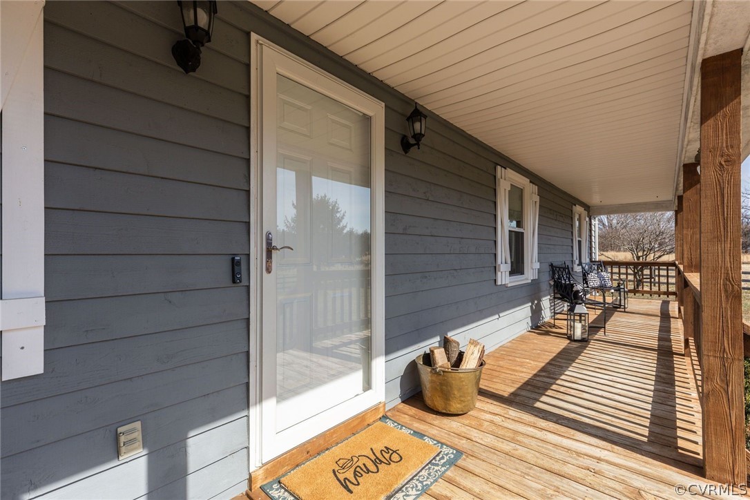 11054 Georgetown Road Mechanicsville, VA 23116 - Photo 6 of 50 a view of a balcony with chair and wooden floor