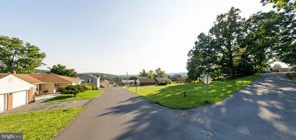 a view of a street with houses on both side