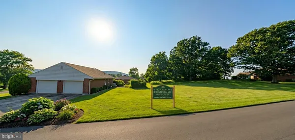 a view of a house with pool and a yard