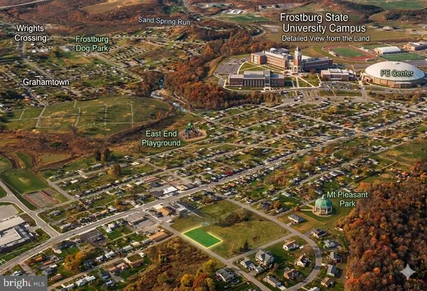 an aerial view of residential houses with city view