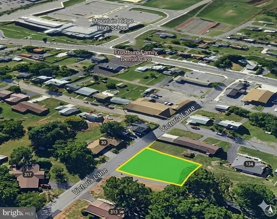 an aerial view of a residential houses with outdoor space and street view