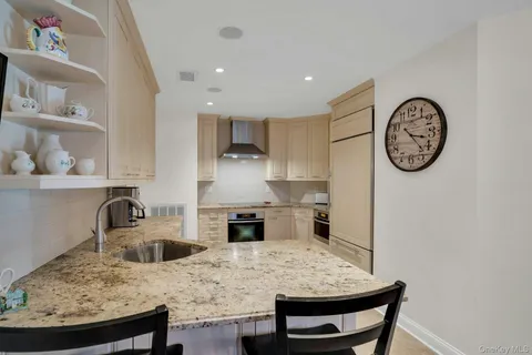 a kitchen with stainless steel appliances granite countertop a stove and a refrigerator