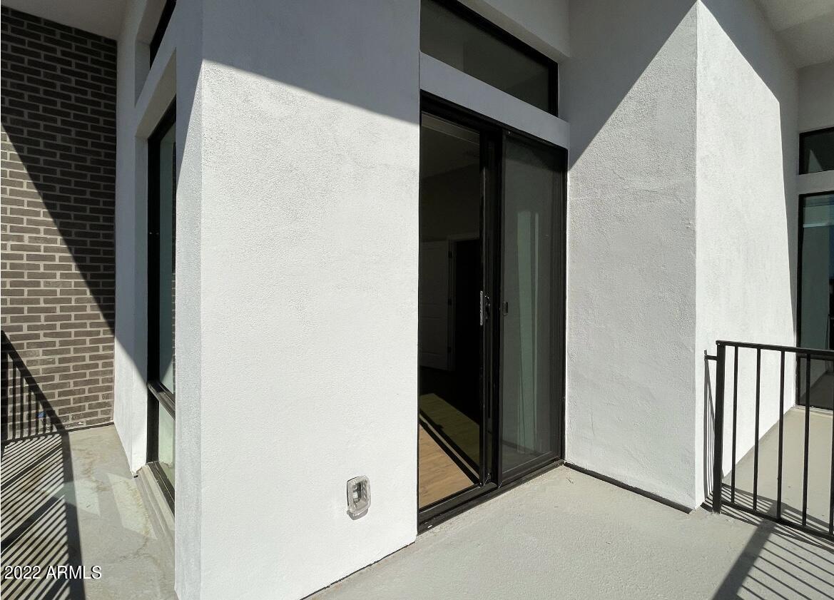 6060 East Baseline Road, Unit 101 Mesa, AZ 85206 - Photo 30 of 52 a view of a hallway with wooden floor and staircase