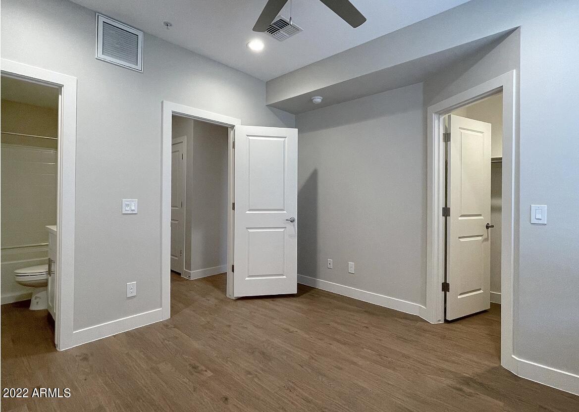 6060 East Baseline Road, Unit 101 Mesa, AZ 85206 - Photo 44 of 52 an empty room with closet and wooden floor