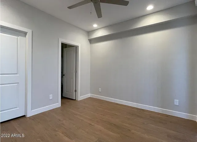 a bathroom with a sink and mirror with bathtub