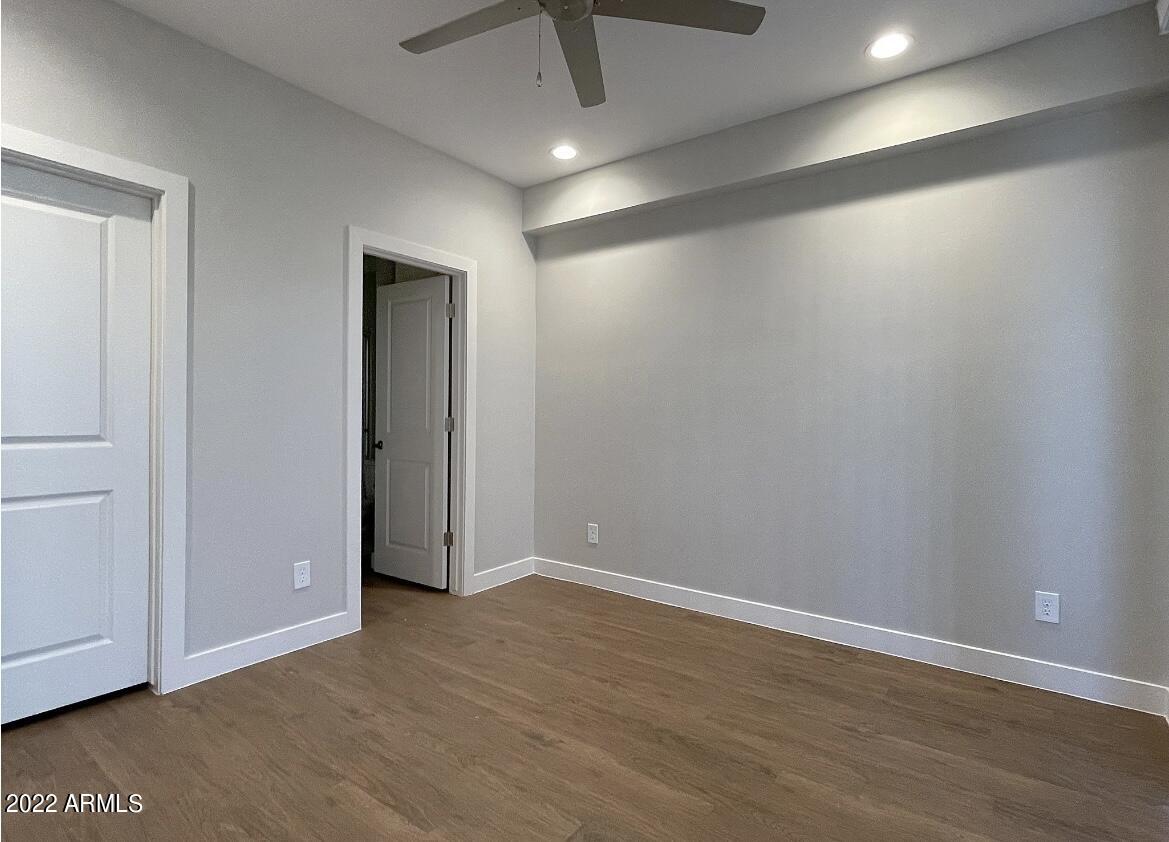 6060 East Baseline Road, Unit 101 Mesa, AZ 85206 - Photo 48 of 52 an empty room with wooden floor and closet area