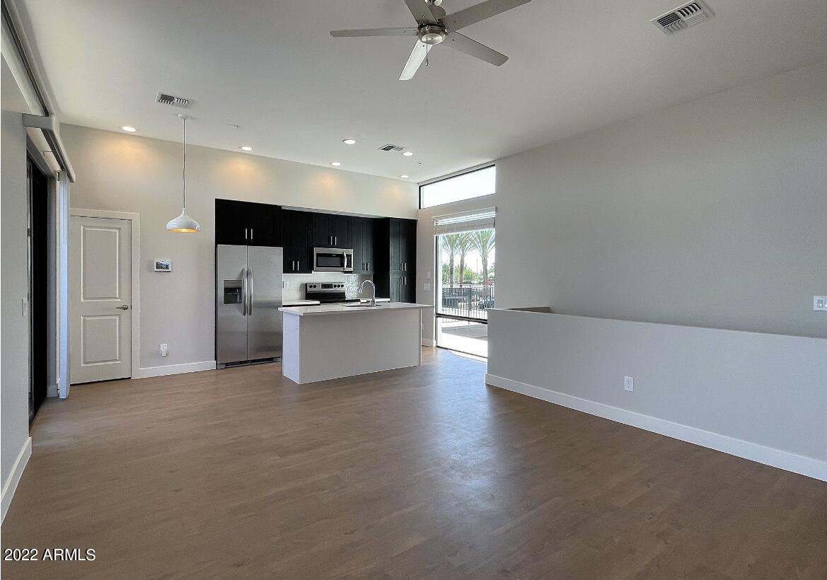6060 East Baseline Road, Unit 101 Mesa, AZ 85206 - Photo 9 of 52 a view of a kitchen with a sink and a refrigerator
