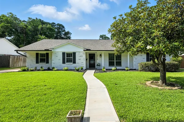 a front view of a house with a yard and porch