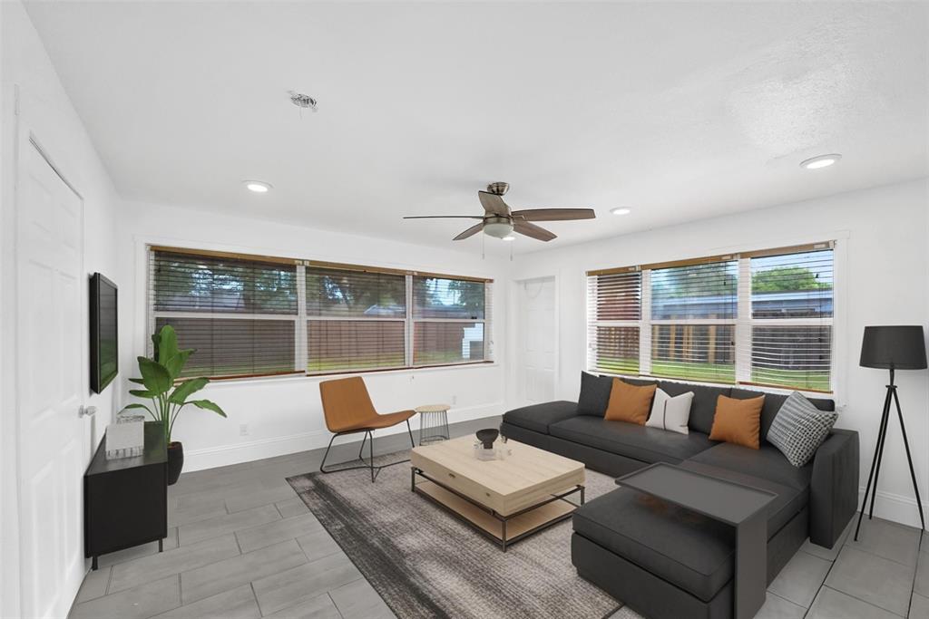 7021 Park Street Hollywood, FL 33024 - Photo 3 of 9 a living room with furniture and floor to ceiling windows