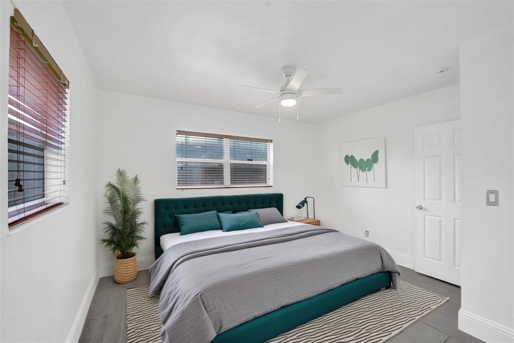 7021 Park Street Hollywood, FL 33024 - Photo 6 of 9 a bedroom with a large bed and wooden floor