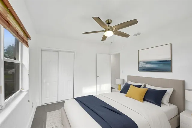 a bedroom with a large bed and a chandelier