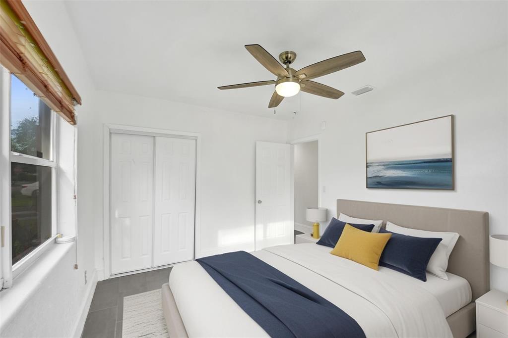 7021 Park Street Hollywood, FL 33024 - Photo 7 of 9 a bedroom with a large bed and a chandelier