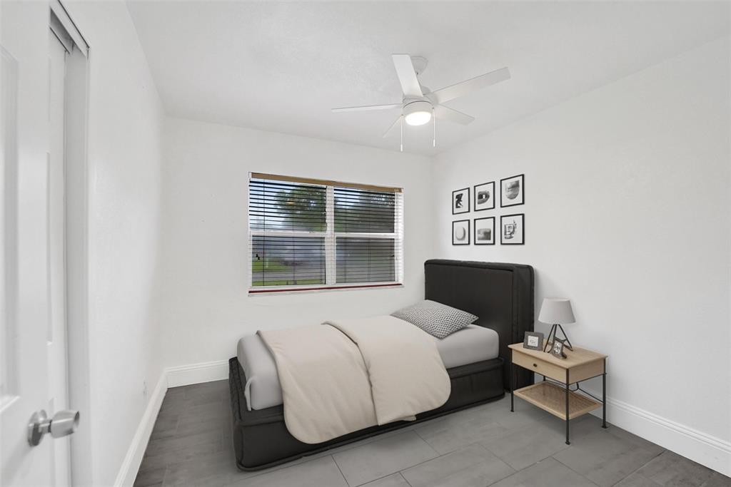 7021 Park Street Hollywood, FL 33024 - Photo 8 of 9 a spacious bedroom with a bed and a window