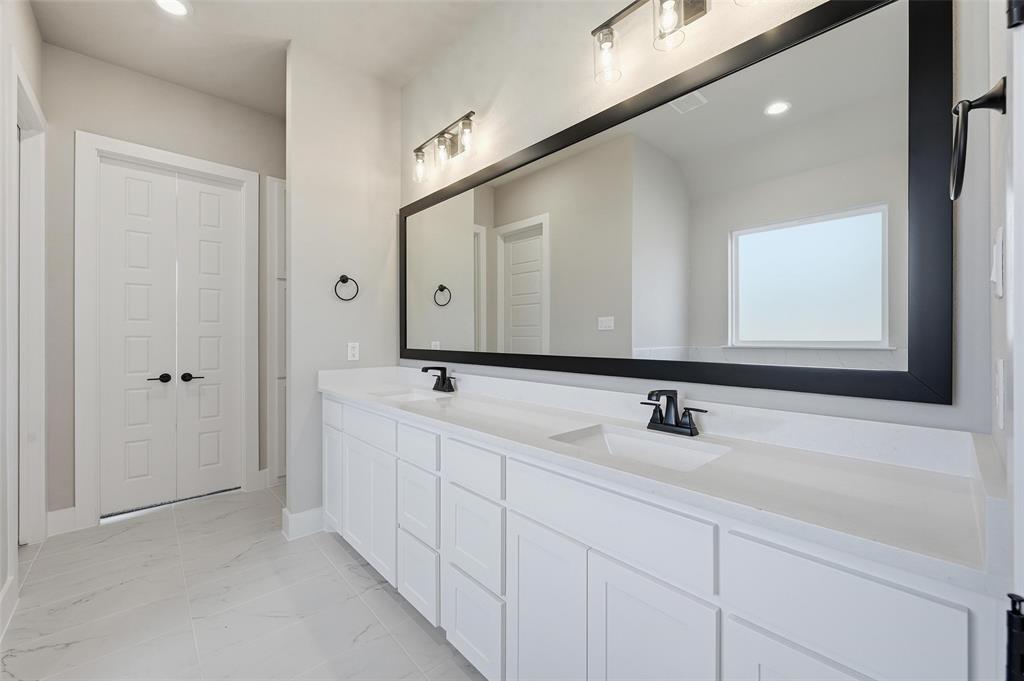 1053 Llano Way Poolville, TX 76487 - Photo 25 of 40 a bathroom with 2 sink and a mirror