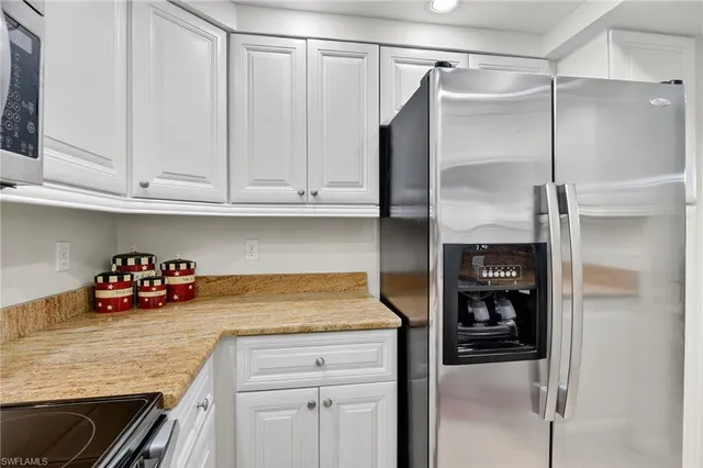 a kitchen with a refrigerator and cabinets