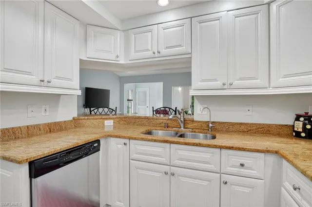 a kitchen with white cabinets and a sink