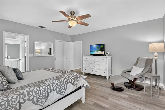 a spacious bedroom with a bed a desk and chair