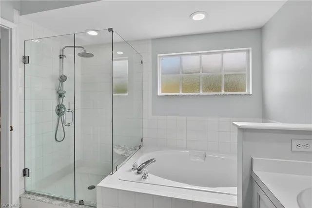 a bathroom with a bath tub and shower