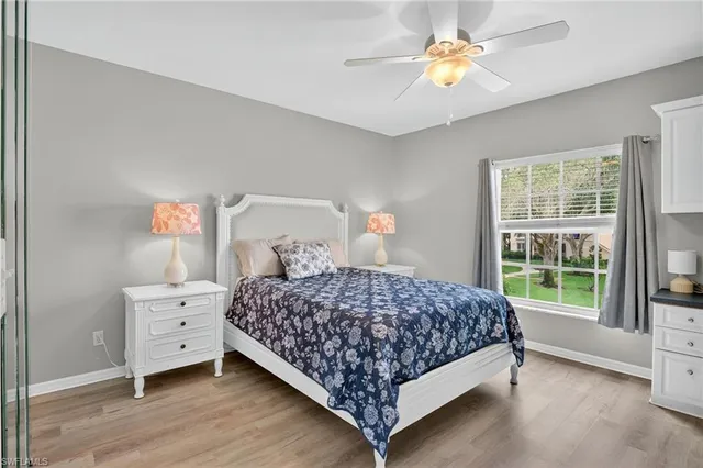 a bedroom with a bed and a chandelier fan