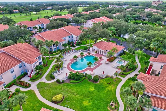an aerial view of residential houses with outdoor space and pool