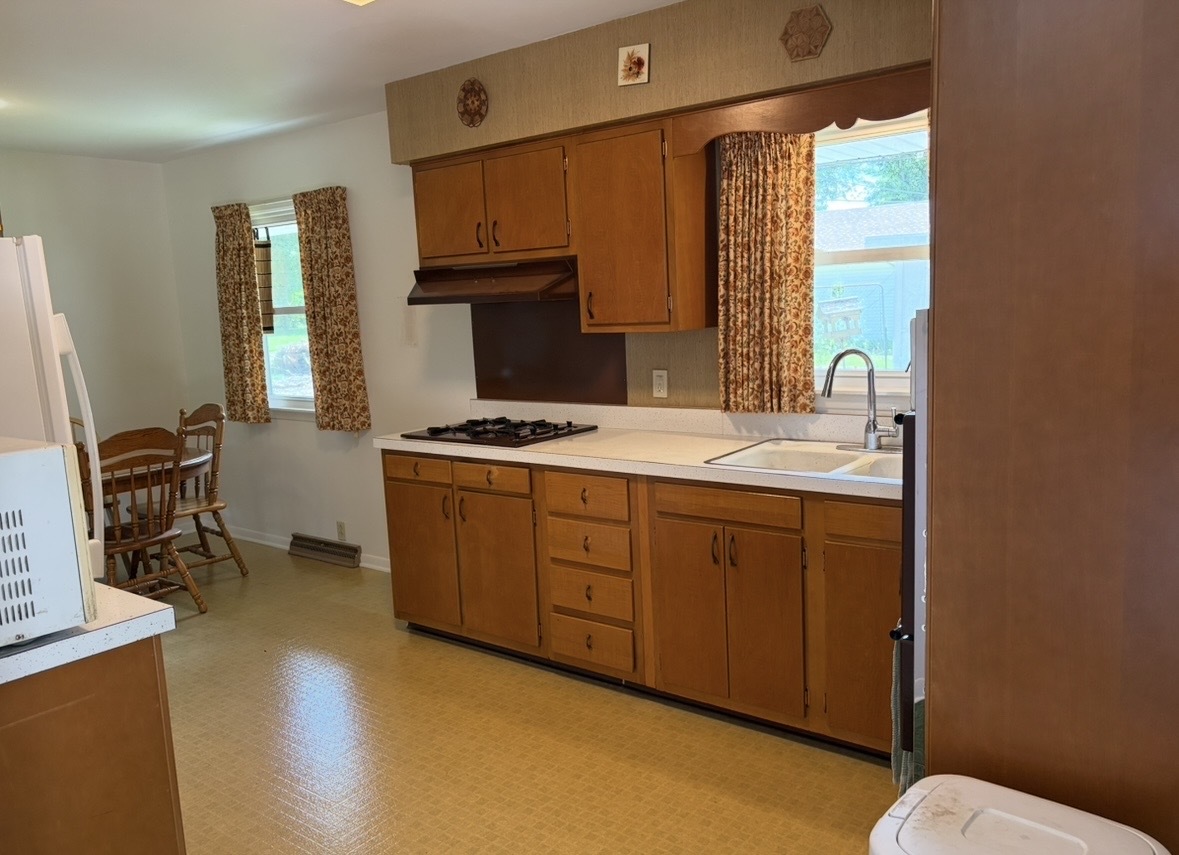 609 9th Avenue Ottawa, IL 61350 - Photo 12 of 28 a kitchen with stainless steel appliances granite countertop a sink stove and cabinets