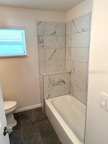 a empty room with windows and closet