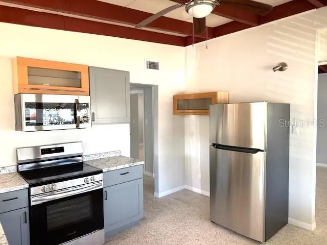 a kitchen with a sink and windows
