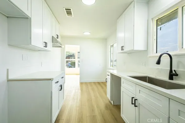 a kitchen with cabinets a sink and appliances