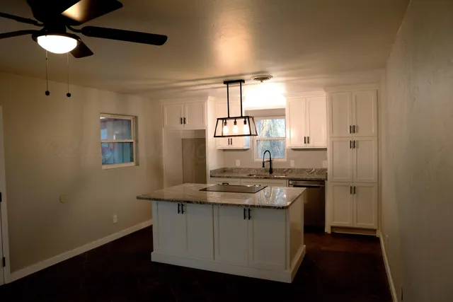 a kitchen with a sink and a refrigerator